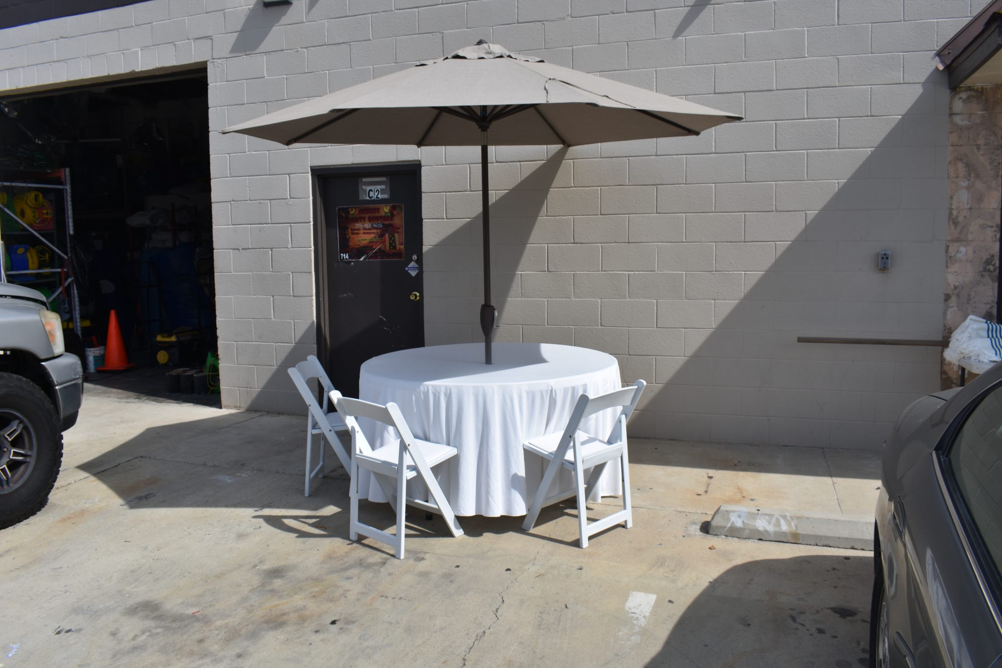 Round Table with Brown Umbrella & White Resin Chairs – Welcome Ashley ...